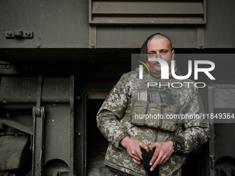 An artilleryman of Ukraine's 118th Separate Mechanized Brigade stands by a self-propelled howitzer while on a mission in the Zaporizhzhia di...