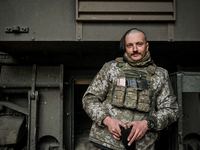 An artilleryman of Ukraine's 118th Separate Mechanized Brigade stands by a self-propelled howitzer while on a mission in the Zaporizhzhia di...