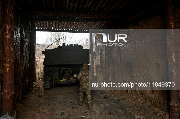 An artilleryman of Ukraine's 118th Separate Mechanized Brigade stands by a self-propelled howitzer while on a mission in the Zaporizhzhia di...