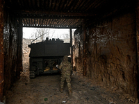 An artilleryman of Ukraine's 118th Separate Mechanized Brigade stands by a self-propelled howitzer while on a mission in the Zaporizhzhia di...