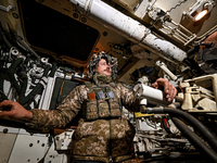 An artilleryman of Ukraine's 118th Separate Mechanized Brigade is inside a self-propelled howitzer while on a mission in the Zaporizhzhia di...