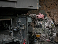 An artilleryman of Ukraine's 118th Separate Mechanized Brigade stands by a self-propelled howitzer while on a mission in the Zaporizhzhia di...