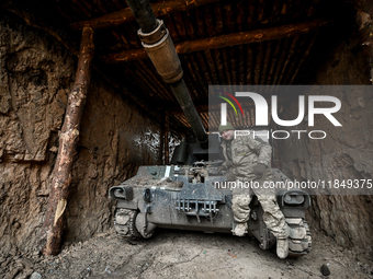 An artilleryman of Ukraine's 118th Separate Mechanized Brigade stands by a self-propelled howitzer while on a mission in the Zaporizhzhia di...