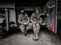 Artillerymen of Ukraine's 118th Separate Mechanized Brigade stand by a self-propelled howitzer while on a mission in the Zaporizhzhia direct...