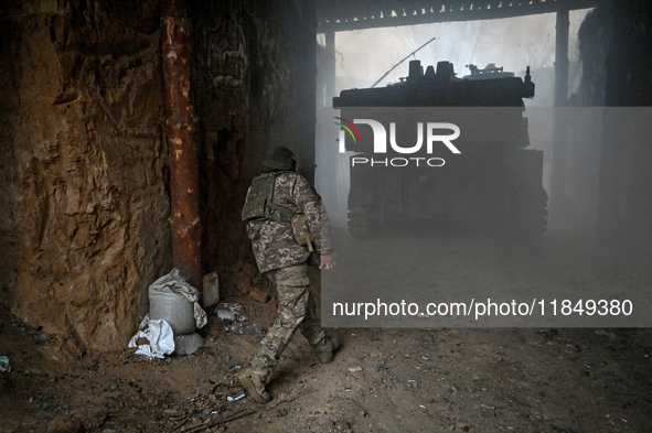 An artilleryman of Ukraine's 118th Separate Mechanized Brigade stands by a self-propelled howitzer while on a mission in the Zaporizhzhia di...