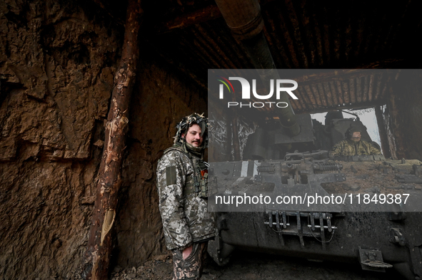 Artillerymen of Ukraine's 118th Separate Mechanized Brigade stand by a self-propelled howitzer while on a mission in the Zaporizhzhia direct...