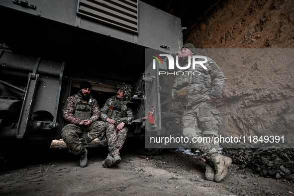 Artillerymen of Ukraine's 118th Separate Mechanized Brigade stand by a self-propelled howitzer while on a mission in the Zaporizhzhia direct...