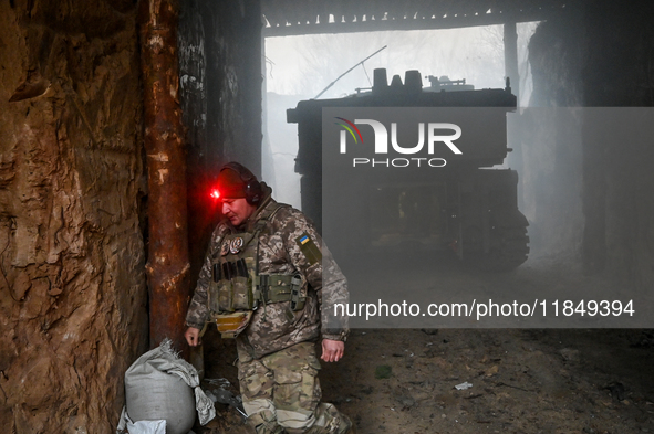 An artilleryman of Ukraine's 118th Separate Mechanized Brigade stands by a self-propelled howitzer while on a mission in the Zaporizhzhia di...