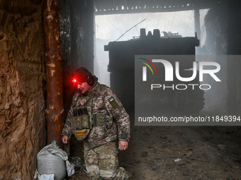 An artilleryman of Ukraine's 118th Separate Mechanized Brigade stands by a self-propelled howitzer while on a mission in the Zaporizhzhia di...