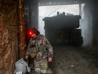 An artilleryman of Ukraine's 118th Separate Mechanized Brigade stands by a self-propelled howitzer while on a mission in the Zaporizhzhia di...