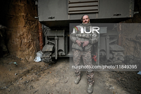 An artilleryman of Ukraine's 118th Separate Mechanized Brigade stands by a self-propelled howitzer while on a mission in the Zaporizhzhia di...