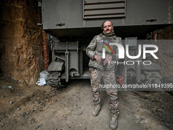 An artilleryman of Ukraine's 118th Separate Mechanized Brigade stands by a self-propelled howitzer while on a mission in the Zaporizhzhia di...