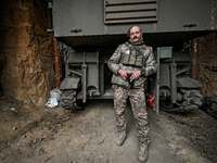 An artilleryman of Ukraine's 118th Separate Mechanized Brigade stands by a self-propelled howitzer while on a mission in the Zaporizhzhia di...