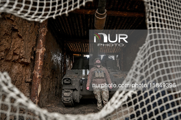 An artilleryman of Ukraine's 118th Separate Mechanized Brigade stands by a self-propelled howitzer while on a mission in the Zaporizhzhia di...