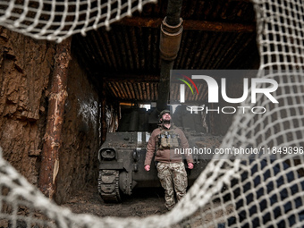 An artilleryman of Ukraine's 118th Separate Mechanized Brigade stands by a self-propelled howitzer while on a mission in the Zaporizhzhia di...