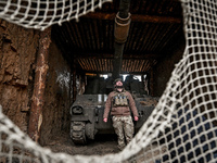 An artilleryman of Ukraine's 118th Separate Mechanized Brigade stands by a self-propelled howitzer while on a mission in the Zaporizhzhia di...