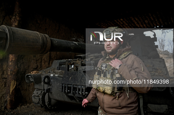 An artilleryman of Ukraine's 118th Separate Mechanized Brigade stands by a self-propelled howitzer while on a mission in the Zaporizhzhia di...