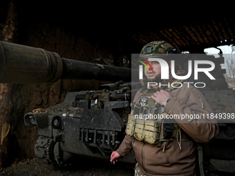 An artilleryman of Ukraine's 118th Separate Mechanized Brigade stands by a self-propelled howitzer while on a mission in the Zaporizhzhia di...