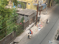 Rag picker children collect plastic bottles and other reusable items from the garbage thrown at the roadside in Siliguri, India, on December...