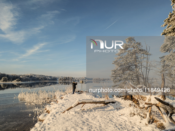 People enjoy a cold winter day at Lakes Osterseen in Iffeldorf, Bavaria, Germany, on January 14, 2024. Osterseen is a group of lakes in Bava...