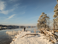 People enjoy a cold winter day at Lakes Osterseen in Iffeldorf, Bavaria, Germany, on January 14, 2024. Osterseen is a group of lakes in Bava...