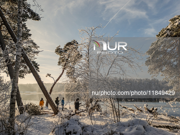 People enjoy a cold winter day at Lakes Osterseen in Iffeldorf, Bavaria, Germany, on January 14, 2024. Osterseen is a group of lakes in Bava...