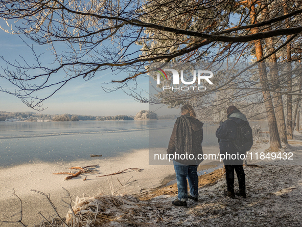 People enjoy a cold winter day at Lakes Osterseen in Iffeldorf, Bavaria, Germany, on January 14, 2024. Osterseen is a group of lakes in Bava...