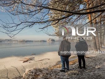 People enjoy a cold winter day at Lakes Osterseen in Iffeldorf, Bavaria, Germany, on January 14, 2024. Osterseen is a group of lakes in Bava...