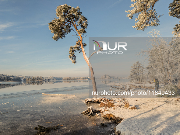 People enjoy a cold winter day at Lakes Osterseen in Iffeldorf, Bavaria, Germany, on January 14, 2024. Osterseen is a group of lakes in Bava...