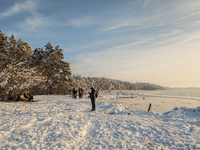 People enjoy a cold winter day at Lakes Osterseen in Iffeldorf, Bavaria, Germany, on January 14, 2024. Osterseen is a group of lakes in Bava...