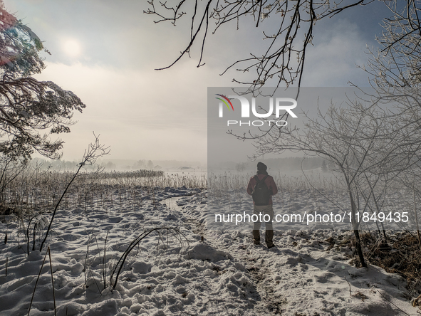 People enjoy a cold winter day at Lakes Osterseen in Iffeldorf, Bavaria, Germany, on January 14, 2024. Osterseen is a group of lakes in Bava...