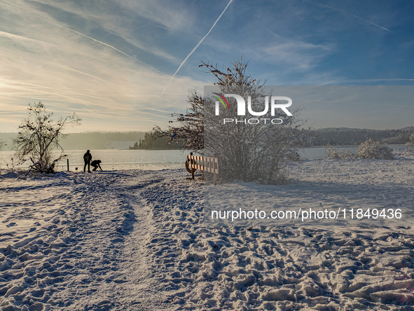 People enjoy a cold winter day at Lakes Osterseen in Iffeldorf, Bavaria, Germany, on January 14, 2024. Osterseen is a group of lakes in Bava...