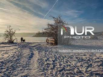 People enjoy a cold winter day at Lakes Osterseen in Iffeldorf, Bavaria, Germany, on January 14, 2024. Osterseen is a group of lakes in Bava...