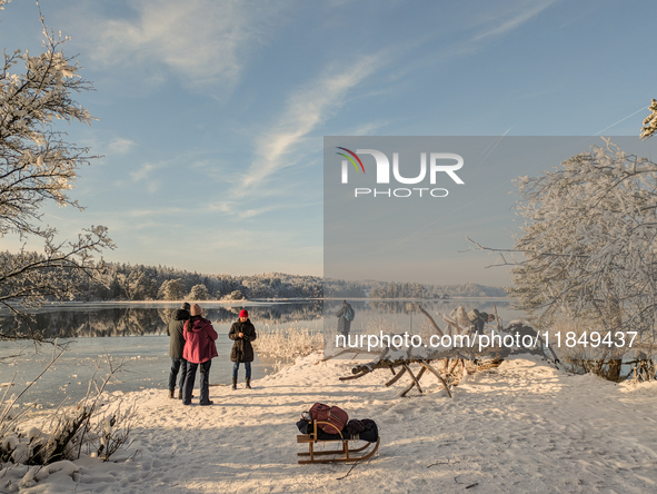 People enjoy a cold winter day at Lakes Osterseen in Iffeldorf, Bavaria, Germany, on January 14, 2024. Osterseen is a group of lakes in Bava...