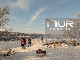 People enjoy a cold winter day at Lakes Osterseen in Iffeldorf, Bavaria, Germany, on January 14, 2024. Osterseen is a group of lakes in Bava...