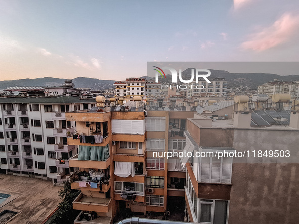 A view of dense housing development at sunset with mountains in the background is seen in Alanya, Turkey, on November 2, 2024 