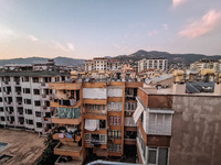 A view of dense housing development at sunset with mountains in the background is seen in Alanya, Turkey, on November 2, 2024 (