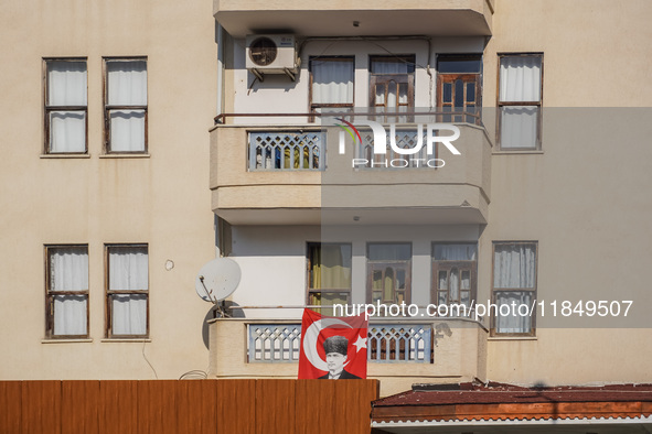 A portrait of Mustafa Kemal Ataturk hangs on the balcony of an apartment building in Alanya, Turkey, on November 3, 2024. 