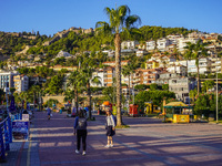 Women walk along a seaside promenade in Alanya, Turkey, on November 3, 2024 (