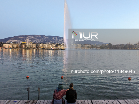 People enjoy an early evening on Lake Geneva in Geneva, Switzerland, on April 9, 2023, watching the Jet d'eau, a fountain in Lake Geneva wit...