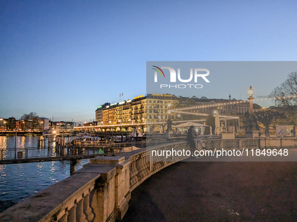 People take an early evening walk at Lake Geneva in Geneva, Switzerland, on April 9, 2023. 