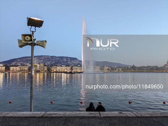 People enjoy an early evening on Lake Geneva in Geneva, Switzerland, on April 9, 2023, watching the Jet d'eau, a fountain in Lake Geneva wit...