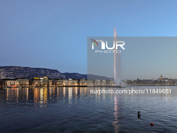 People enjoy an early evening on Lake Geneva in Geneva, Switzerland, on April 9, 2023, watching the Jet d'eau, a fountain in Lake Geneva wit...