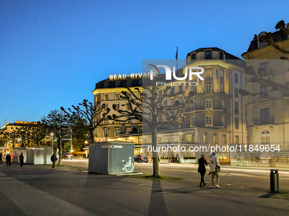 People take an early evening walk in Geneva, Switzerland, on April 9, 2023 