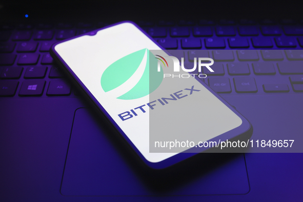 The logo of the cryptocurrency exchange Bitfinex appears on the screen of a smartphone in Reno, United States, on December 9, 2024. 