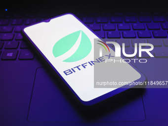 The logo of the cryptocurrency exchange Bitfinex appears on the screen of a smartphone in Reno, United States, on December 9, 2024. (