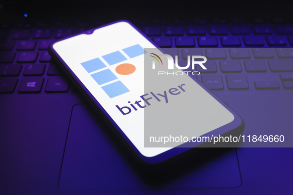 The logo of the cryptocurrency exchange bitFlyer appears on the screen of a smartphone in Reno, United States, on December 9, 2024. 