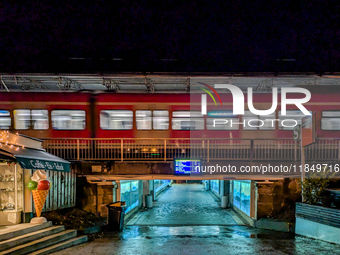 At Starnberg Station in Upper Bavaria, Germany, on December 7, 2024, a suburban S-Bahn train, line S6, moves at night, connecting the Munich...