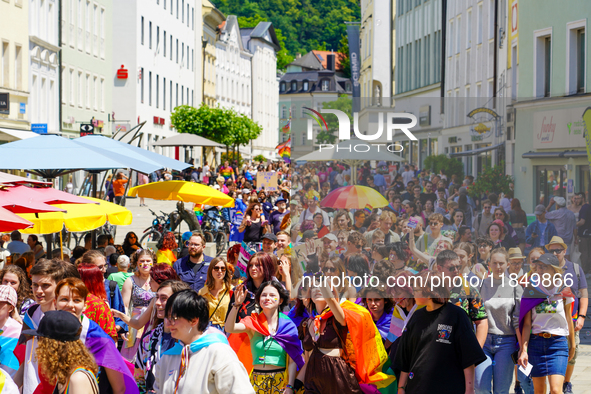 A lively Christopher Street Day, CSD parade winds through the historic streets of Passau's old city in Bavaria, Germany, on June 17, 2023. T...