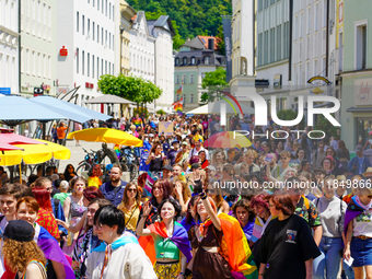 A lively Christopher Street Day, CSD parade winds through the historic streets of Passau's old city in Bavaria, Germany, on June 17, 2023. T...